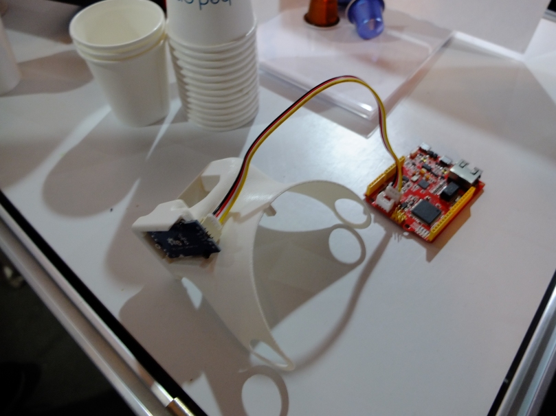 The sensor and microcontroller that are attached to the Nespresso machine. The sensor is mounted on a 3D-printed piece of plastic.